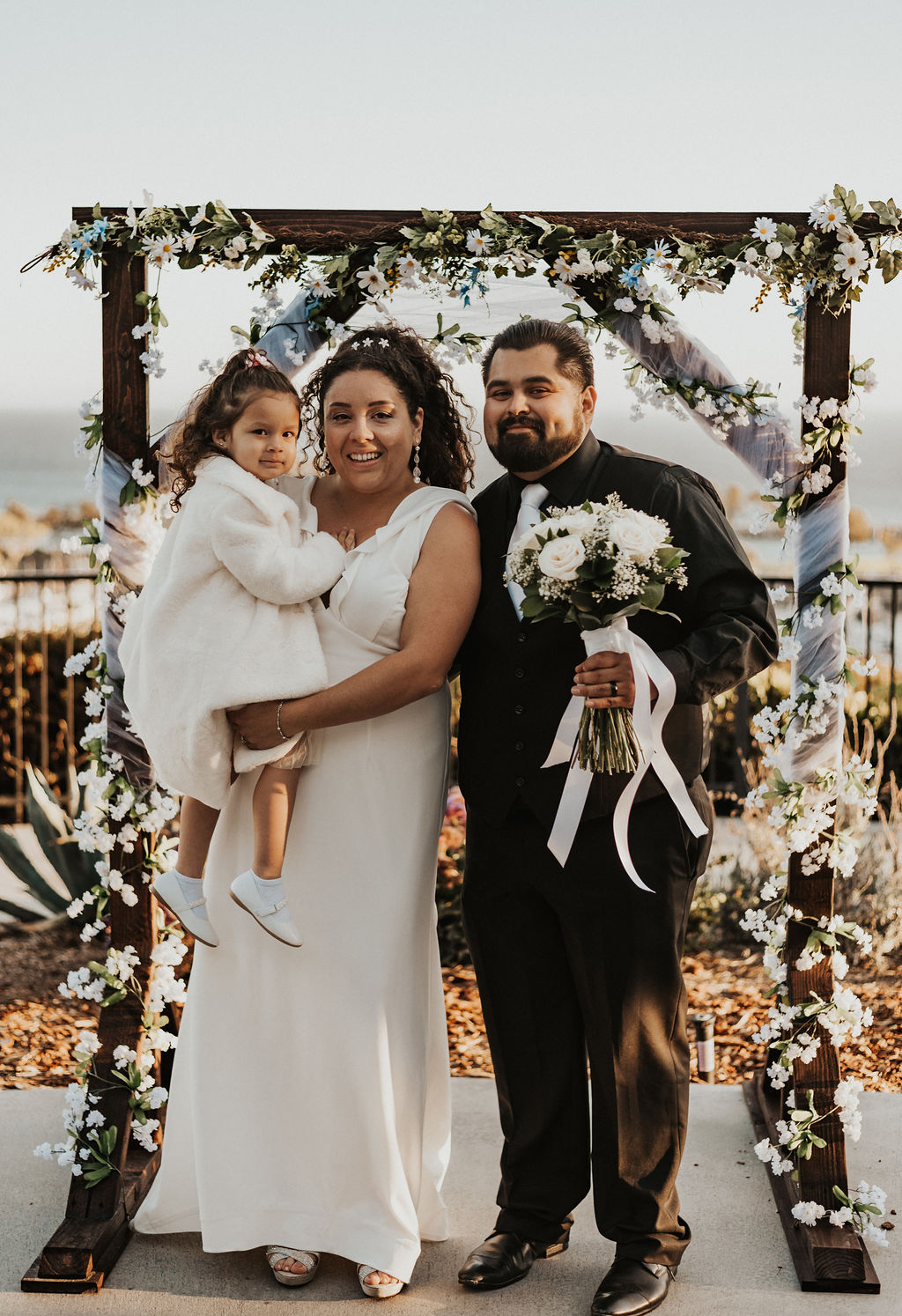 family photo under wedding arch