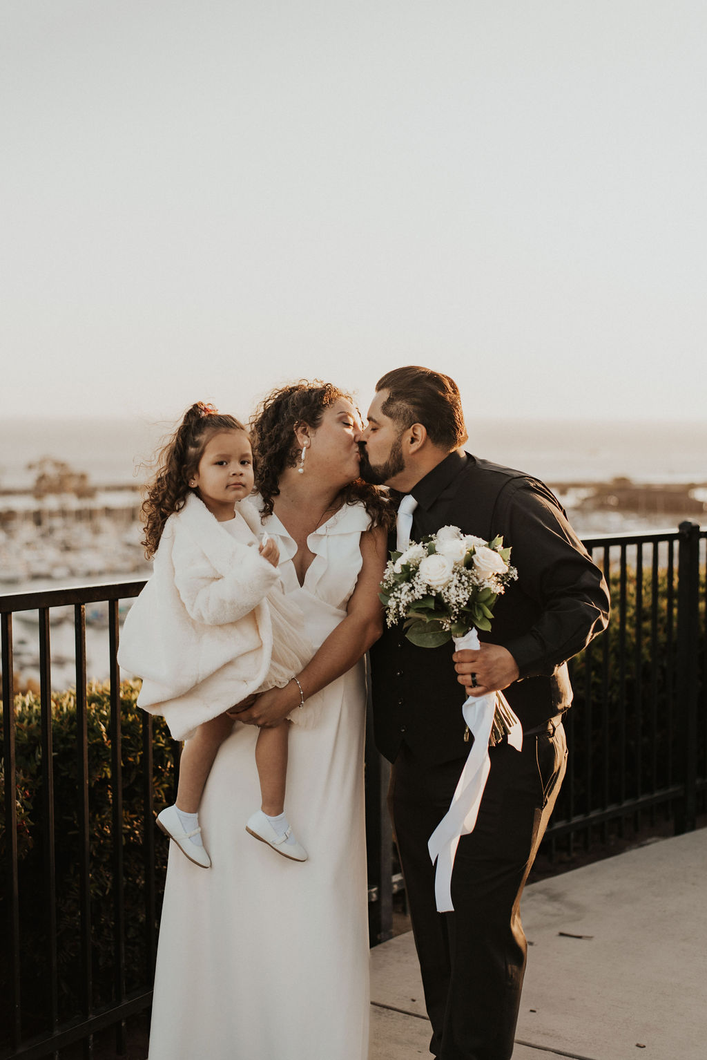 bride and groom with their daughter