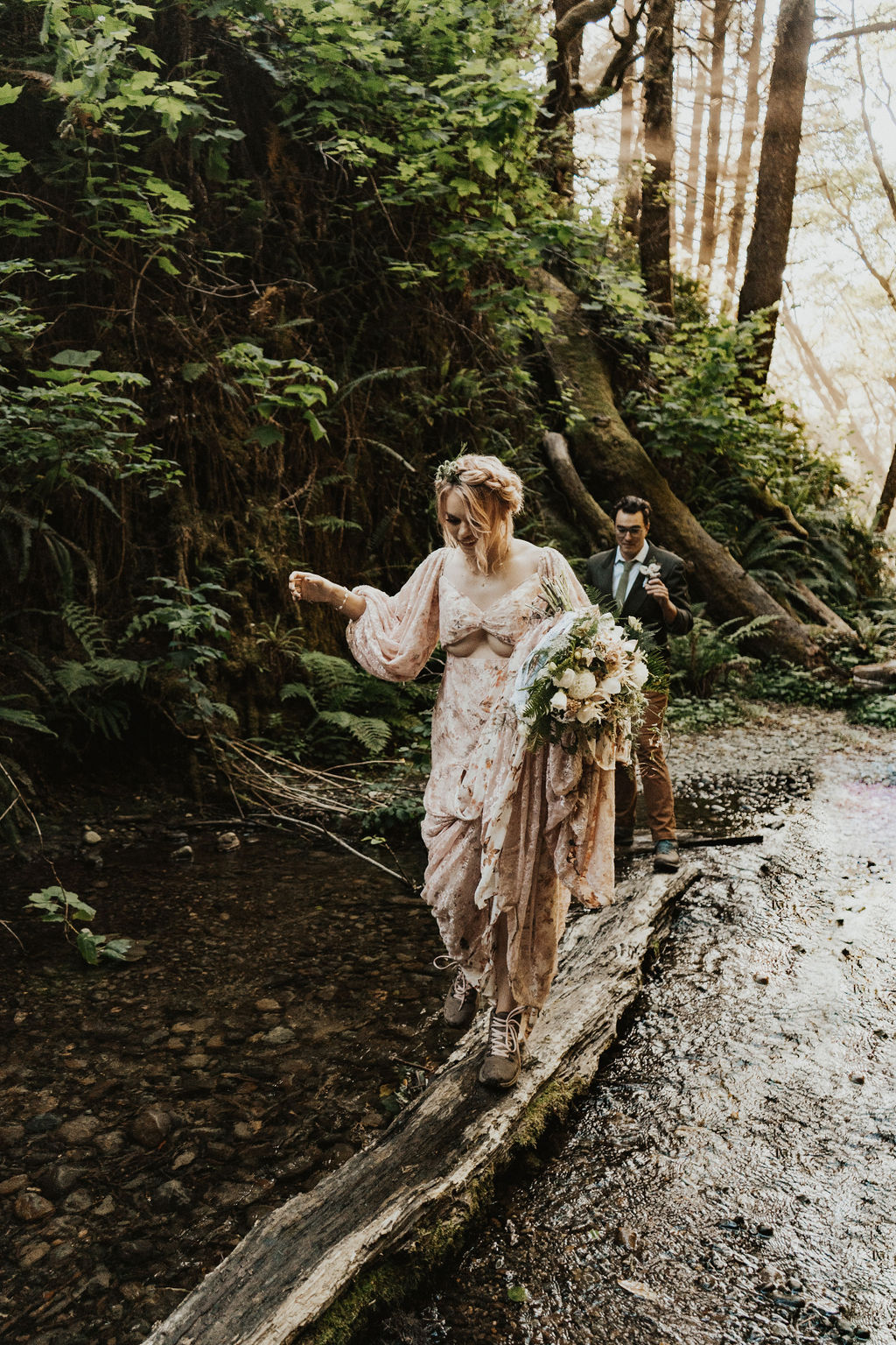 bride and groom hiking through redwoods at their adventure elopement 