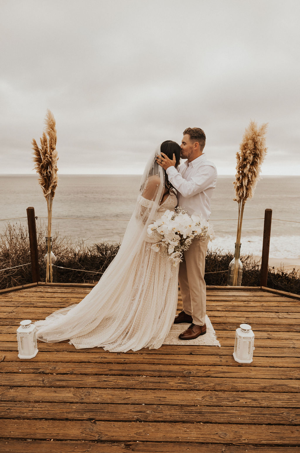 groom kissed brides forehead at this timeless beach wedding