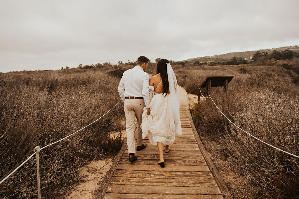 bride and groom walking away from the camera at this southern california elopement 