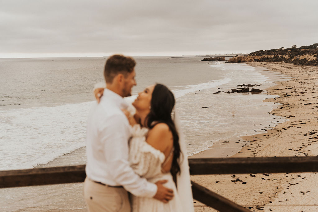 blurry bride and groom photo over looking the ocean at their southern california elopement 