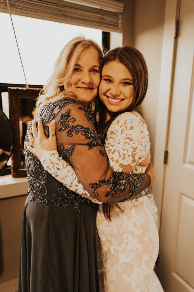 bride hugs her mother as she gets ready for her wedding day