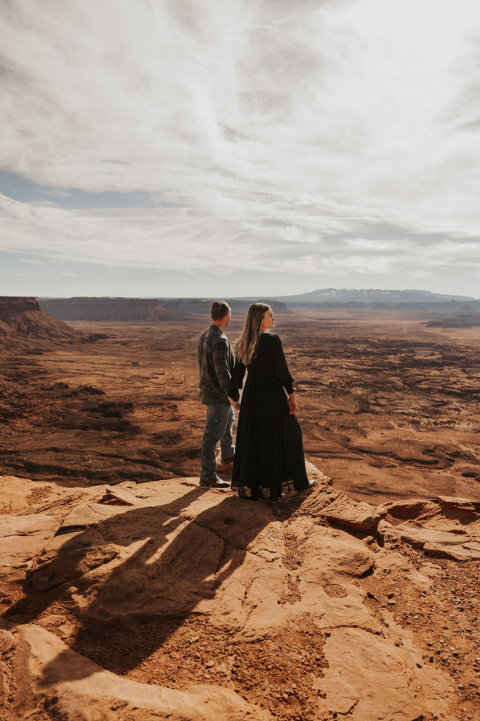 Couple hold hands at Needles Overlook