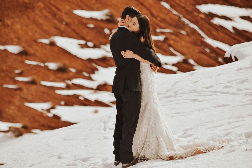 couple eloping in Moab for their snowy wedding 