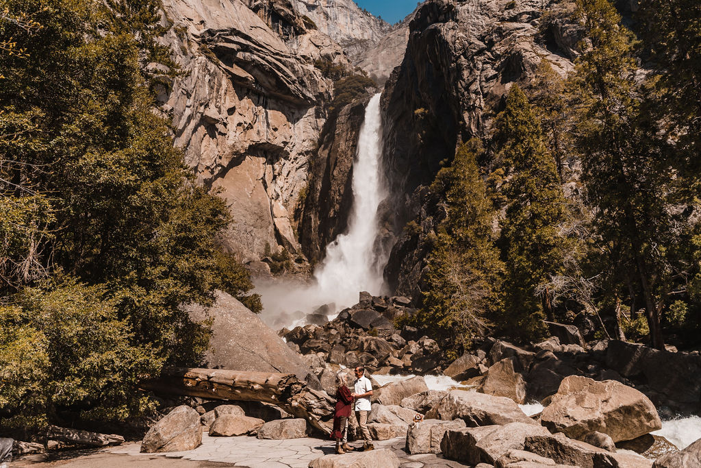 couple has their elopement ceremony in front of waterfall at yosemite