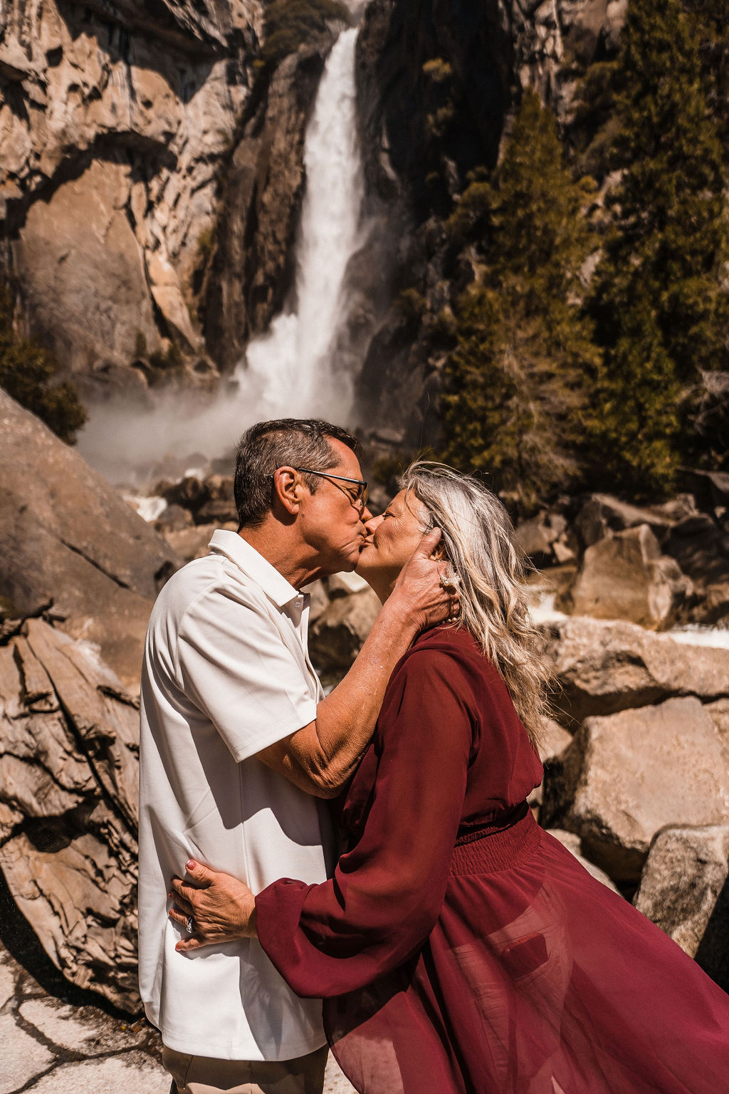 couple kissing at their waterfall Yosemite elopement