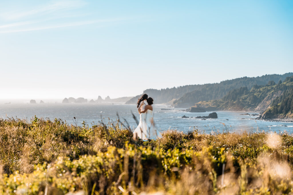 LGBTQ couple shares a kiss overlooking the ocean 