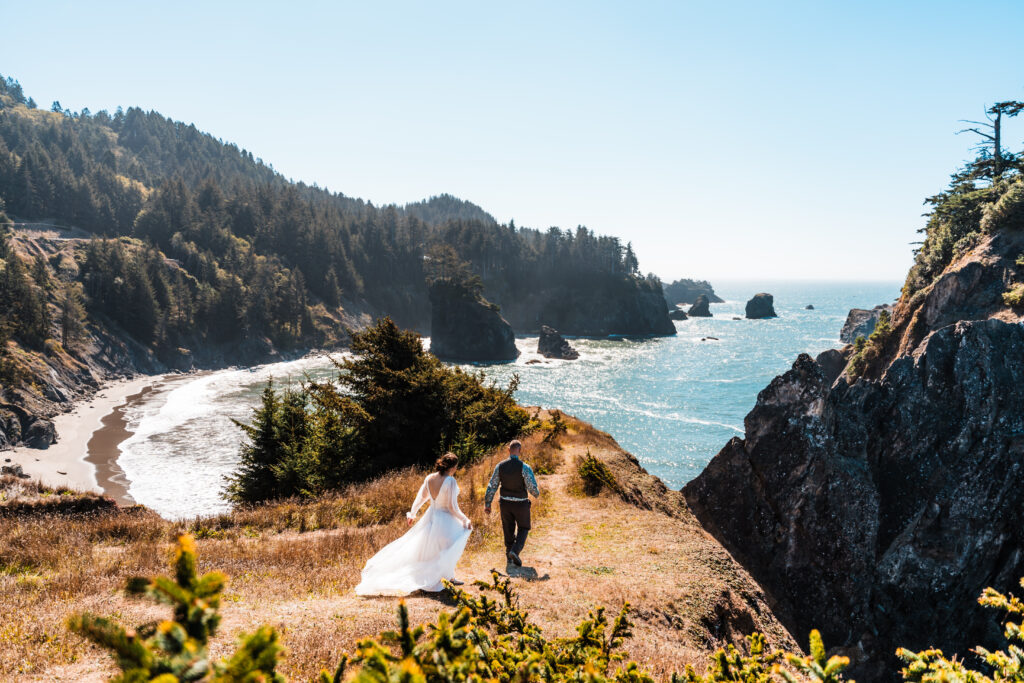 Couple walking down a trail to an ocean overlook