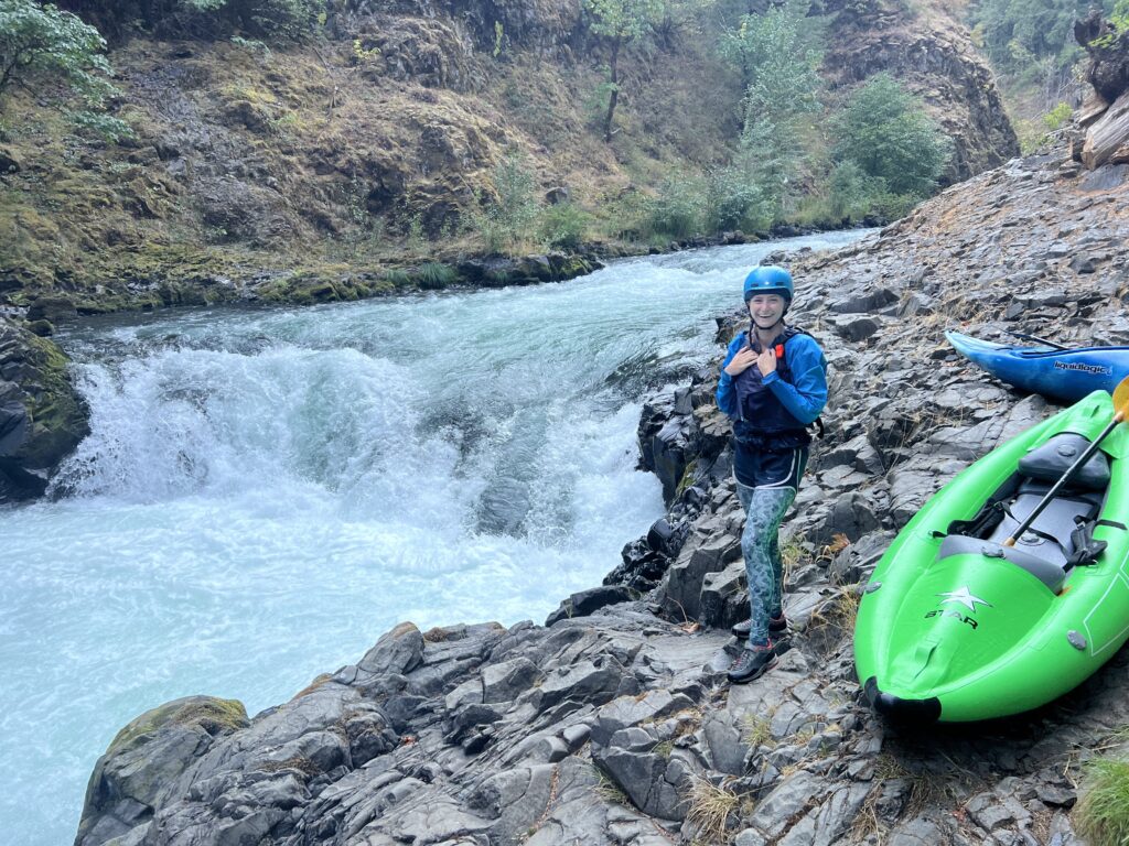 Person scouting rapid on white salmon river with a kayak