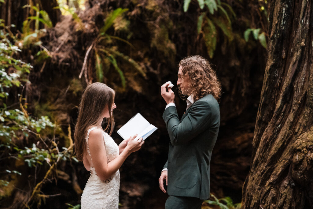 couple crying while exhanging vows in redwood forest