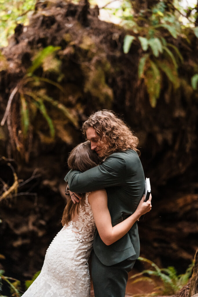 couple hugging after getting married in redwood national park