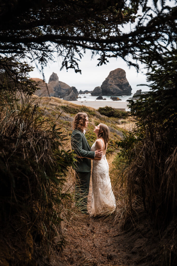 couple stopping for a photo op on a trail on the oregon coast